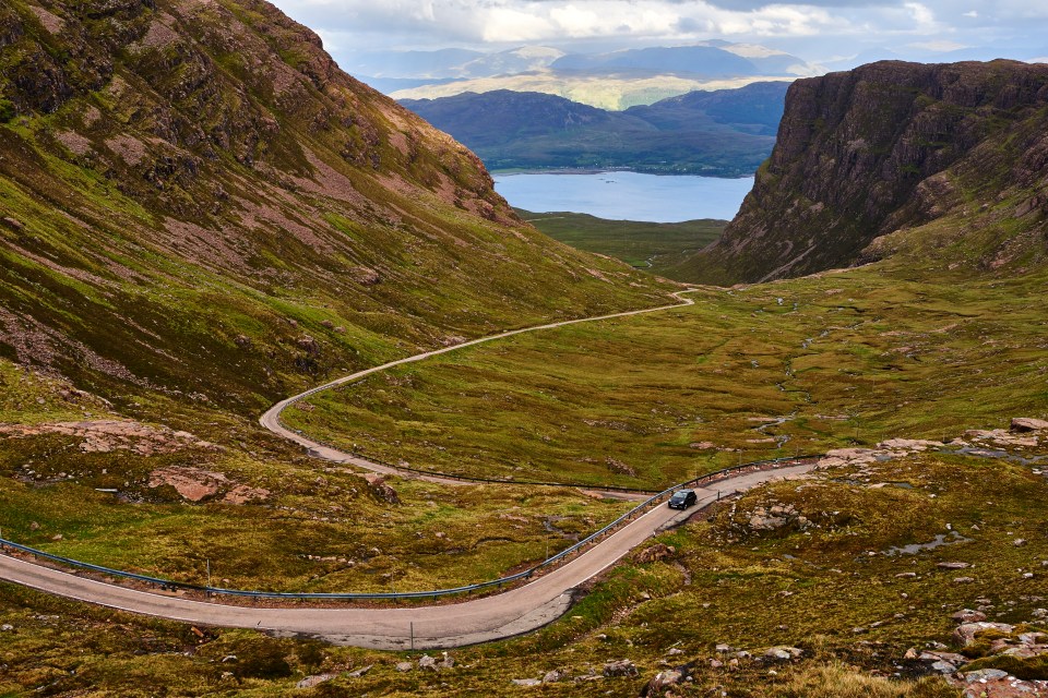 A winding road through the Scottish Highlands.