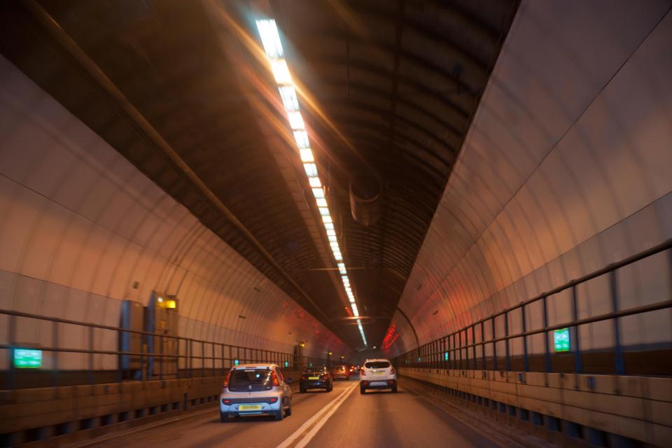 Cars driving through the Dartford Tunnel.