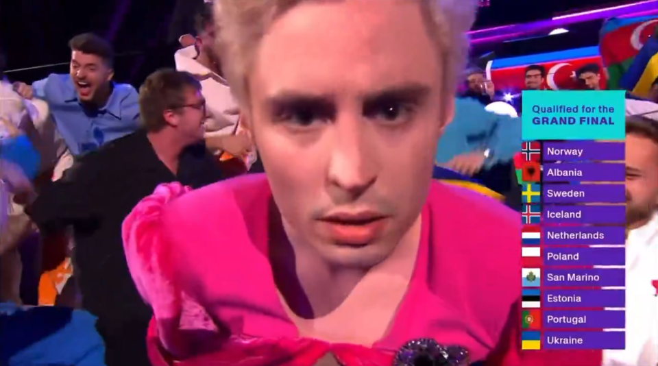 Person in pink reacting to countries qualifying for a grand final.