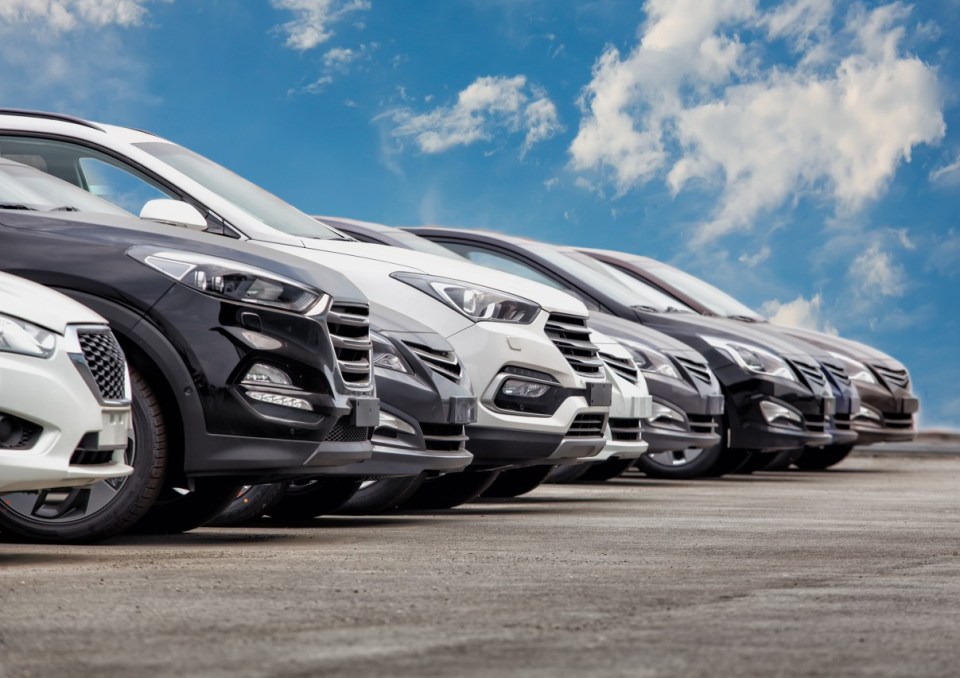 Row of cars for sale in a stock lot.