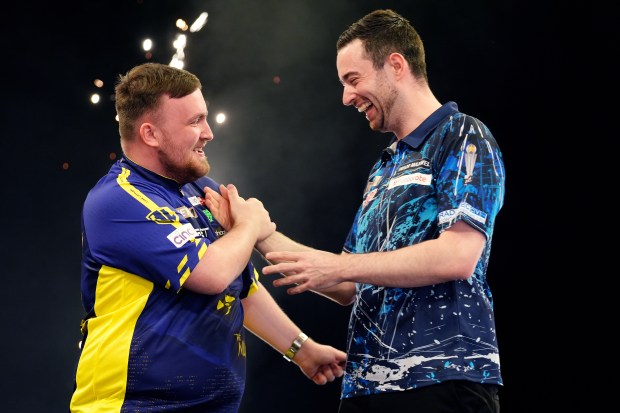 Luke Littler and Luke Humphries shaking hands after a darts match.