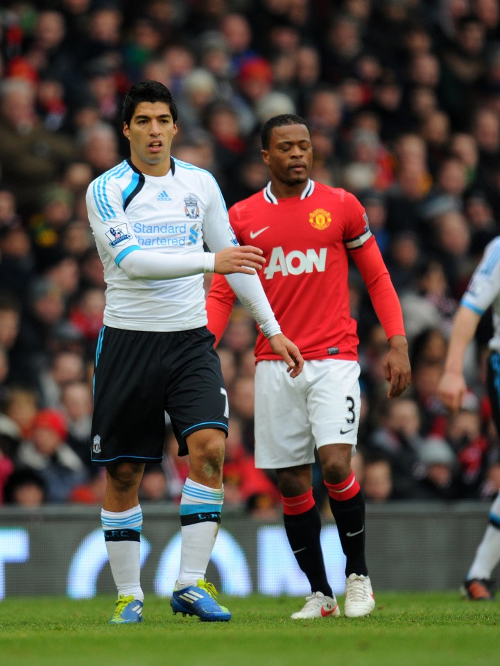 Patrice Evra and Luis Suarez on a soccer field.
