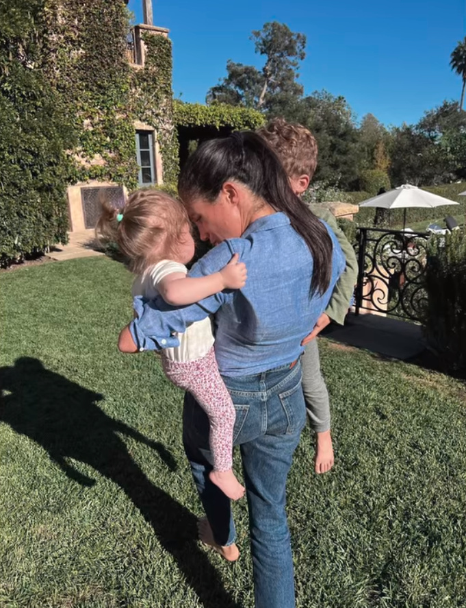 Meghan Markle carrying her two children.