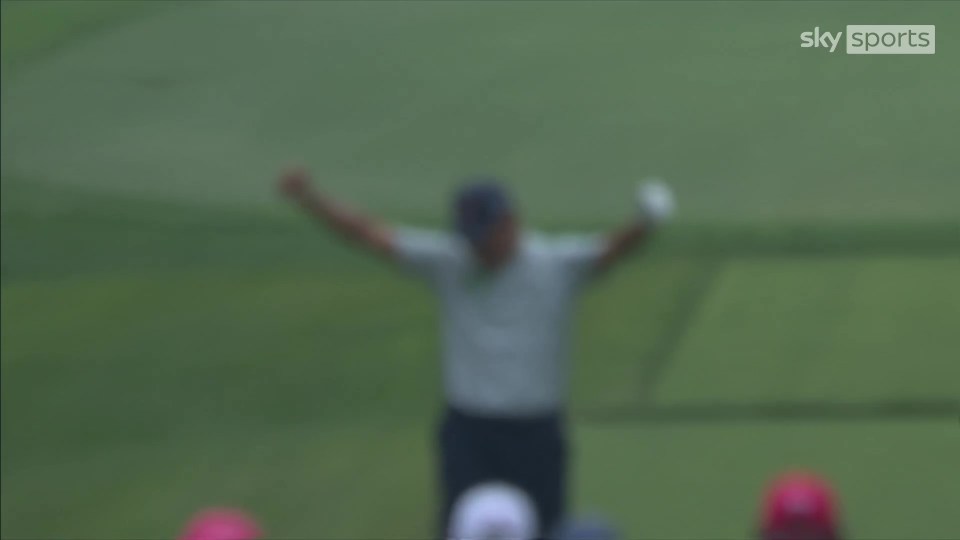 Blurry image of Si Woo Kim celebrating a hole-in-one.