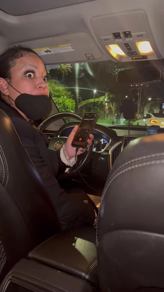 Woman in a car calling emergency services.